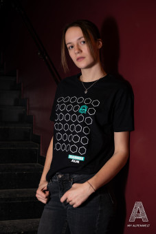 Black T-shirt with pattern and Hannes Alm logo on the front